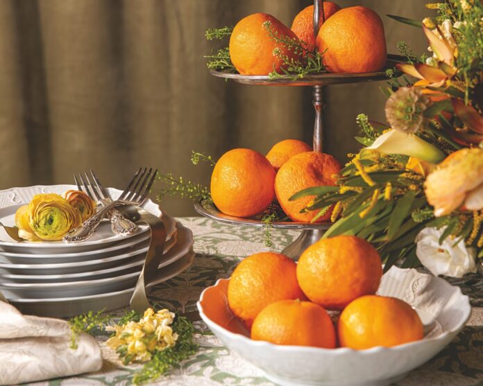 A tiered stand filled with tangerine oranges.