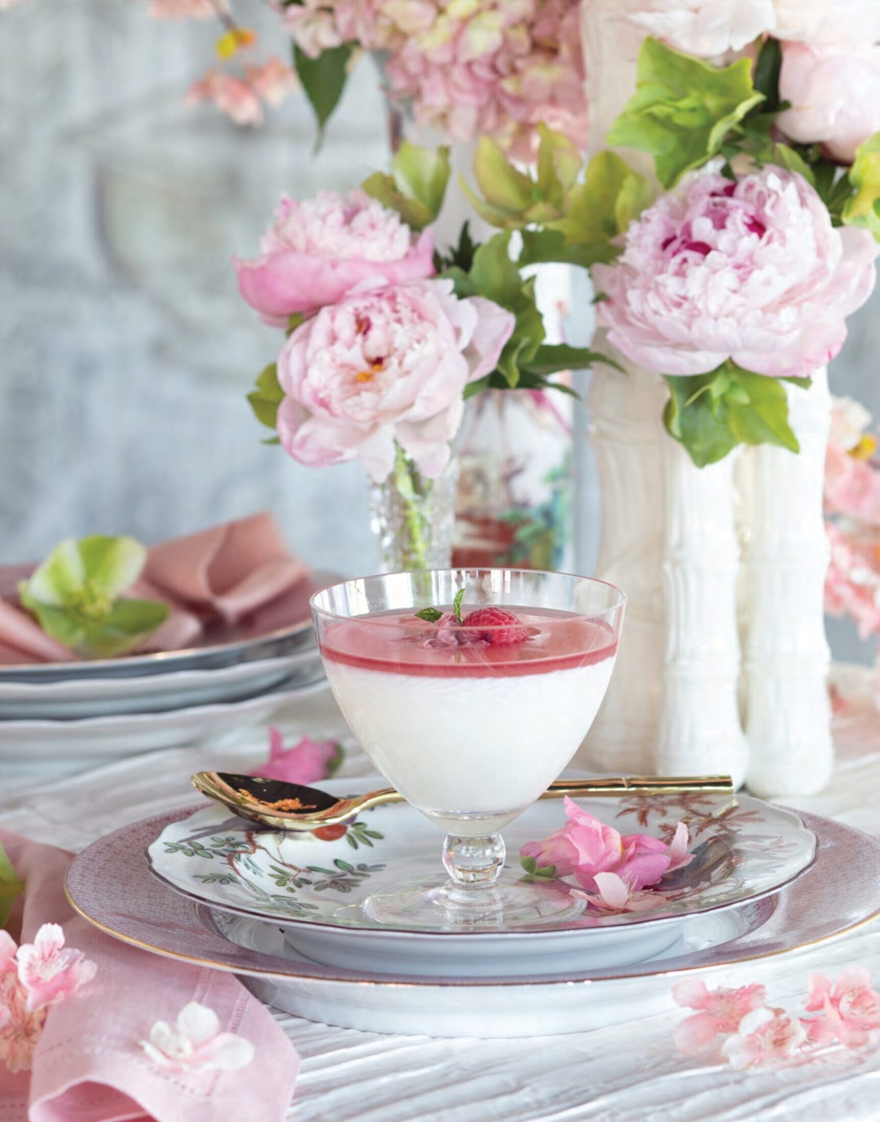 Milk Pudding on a plate surrounded by cherry blossoms and other pink flowers.