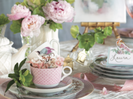 A japanese-inspired tea setting with pink hues and cherry blossom accents.
