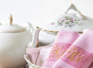 Behind the Cupboard Door: Dust off Your Dishes and Linens Pink embroidered linen napkins with a tea set.