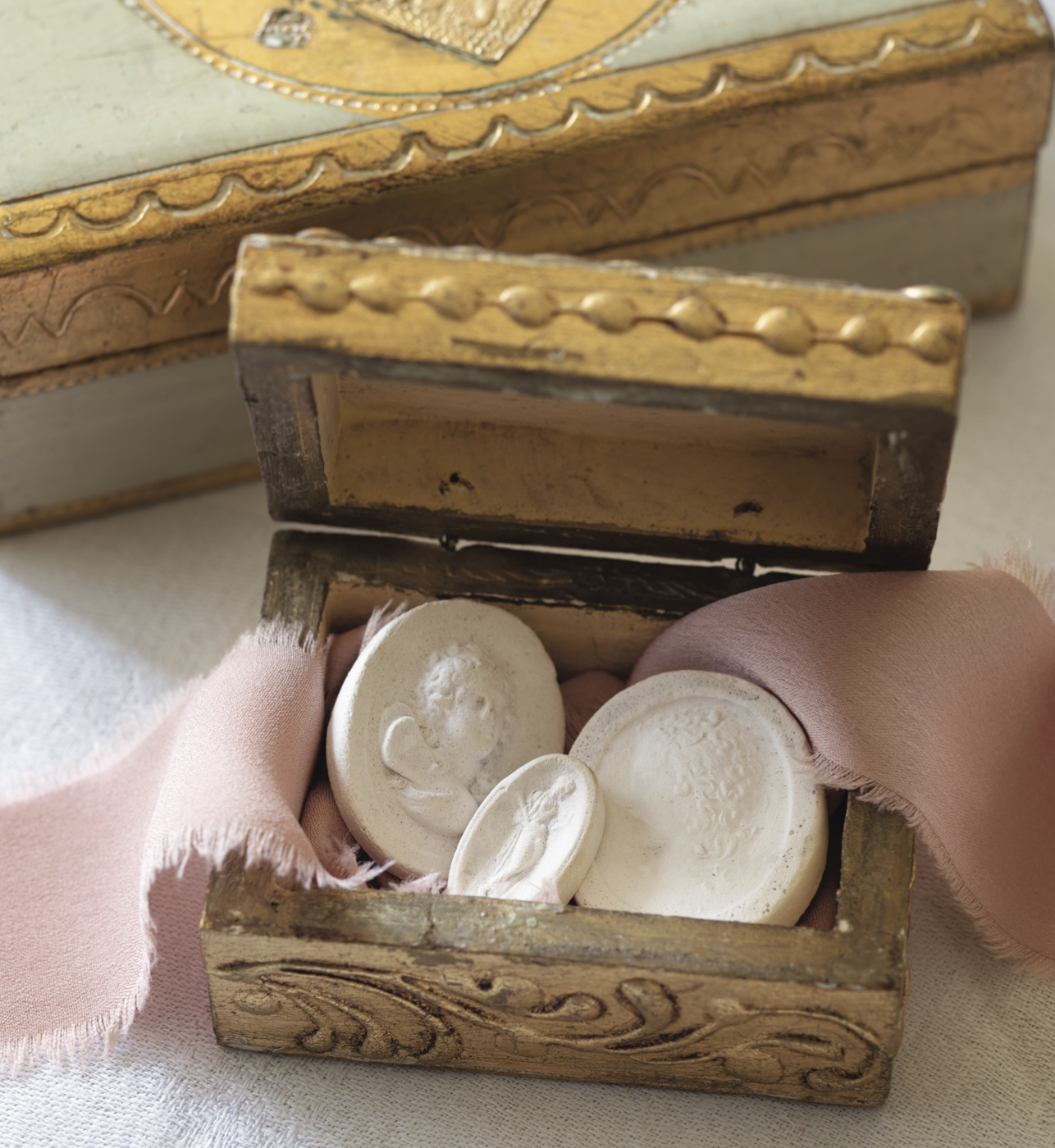 Three intaglios inside a small box with ribbon.