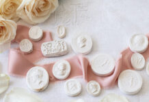 Plaster intaglios with a pink ribbon and roses