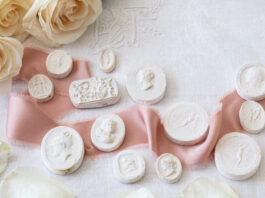 Plaster intaglios with a pink ribbon and roses