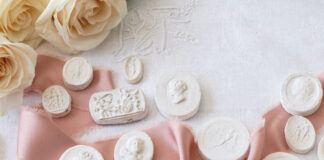 Plaster intaglios with a pink ribbon and roses