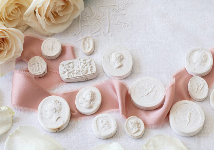 Plaster intaglios with a pink ribbon and roses