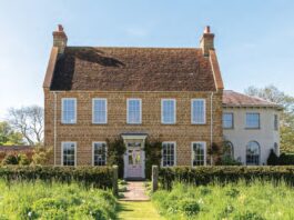 The English country house exterior of Ashbrook, surrounded by gardens.