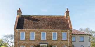 The English country house exterior of Ashbrook, surrounded by gardens.