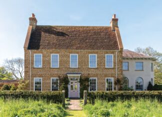The English country house exterior of Ashbrook, surrounded by gardens.