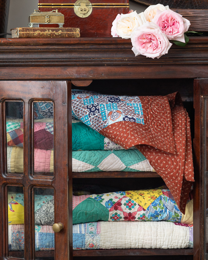 Quilts folded in a wooden cabinet