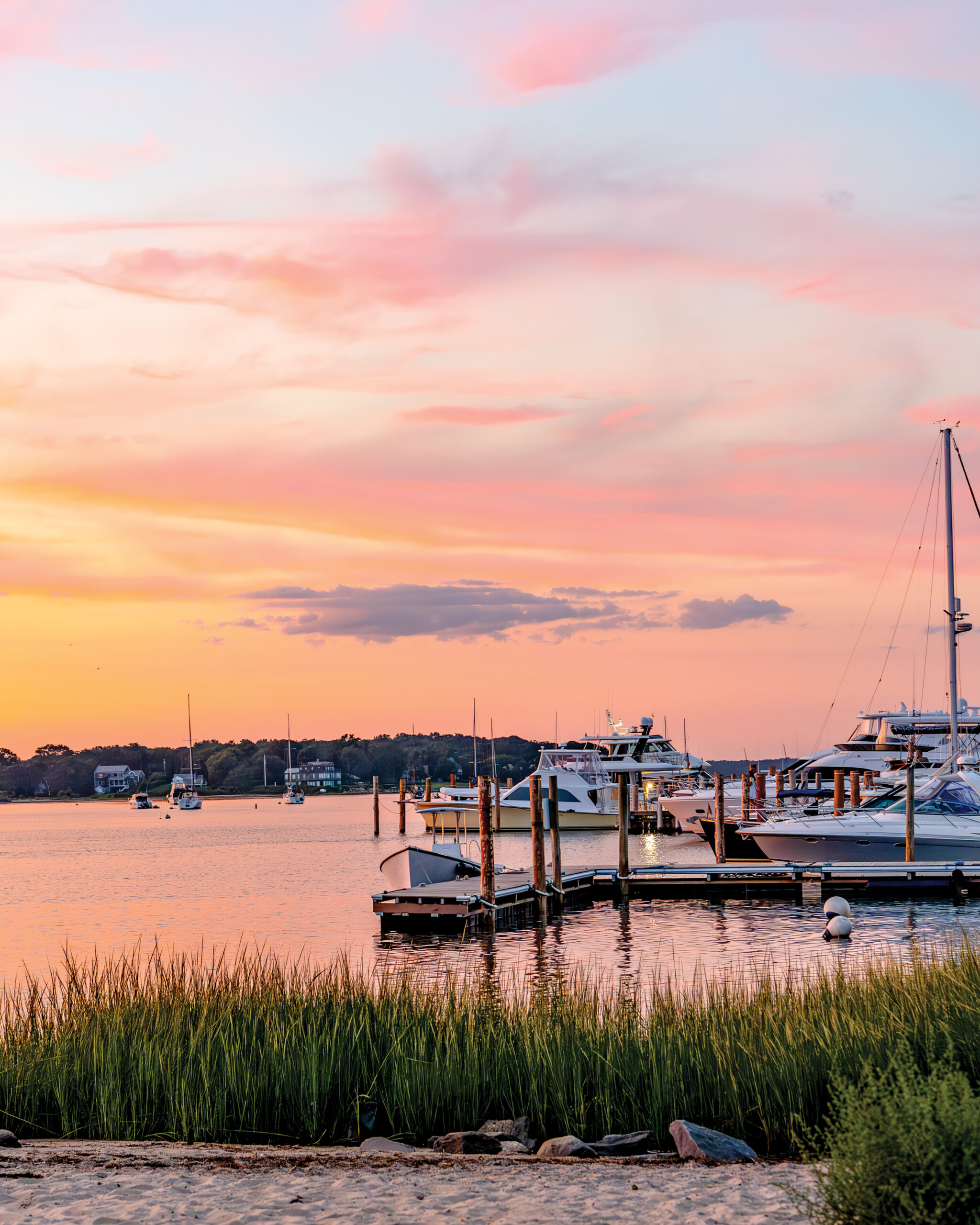 Boats in harbor during sunset