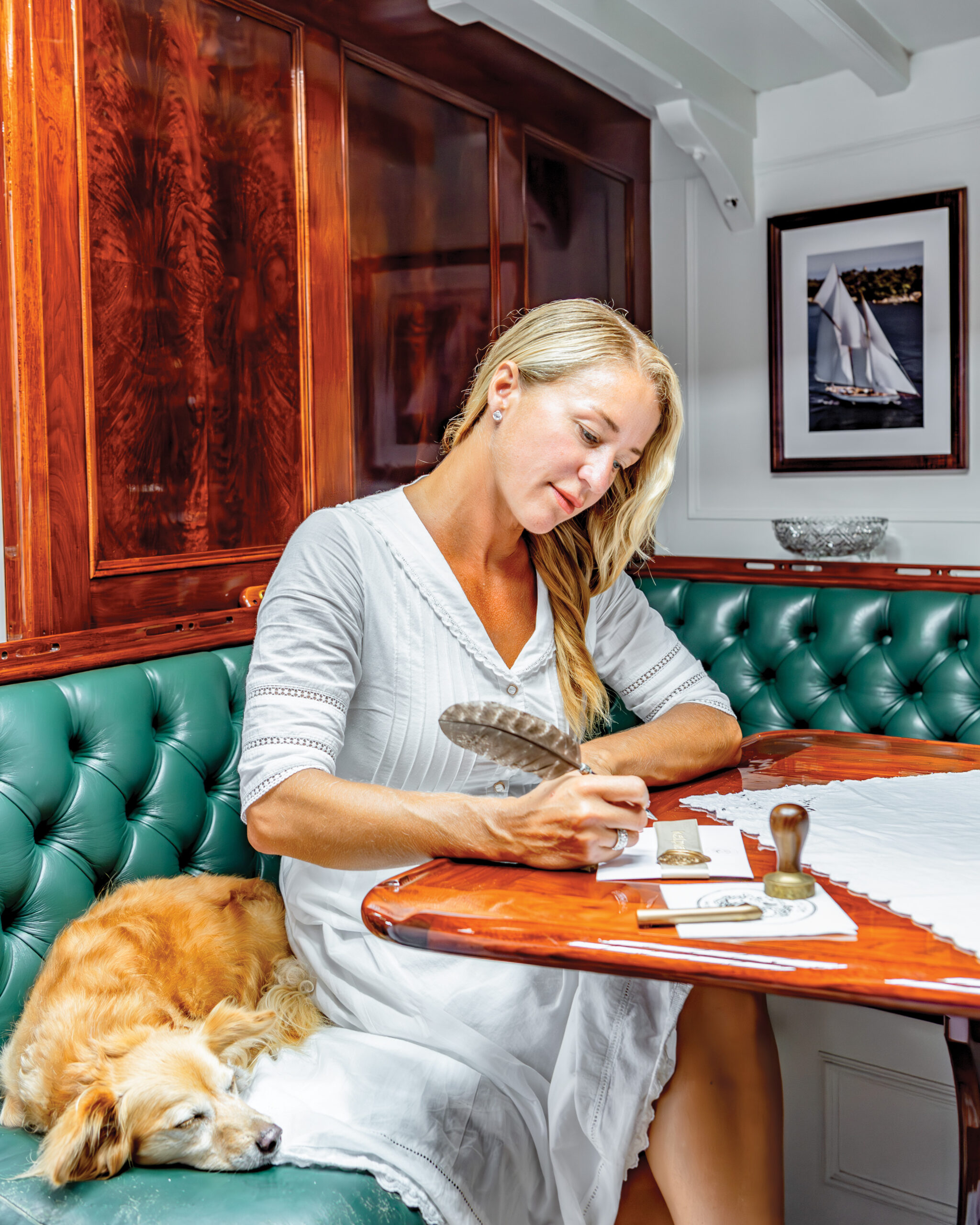 Woman writing letters next to a dog sleeping