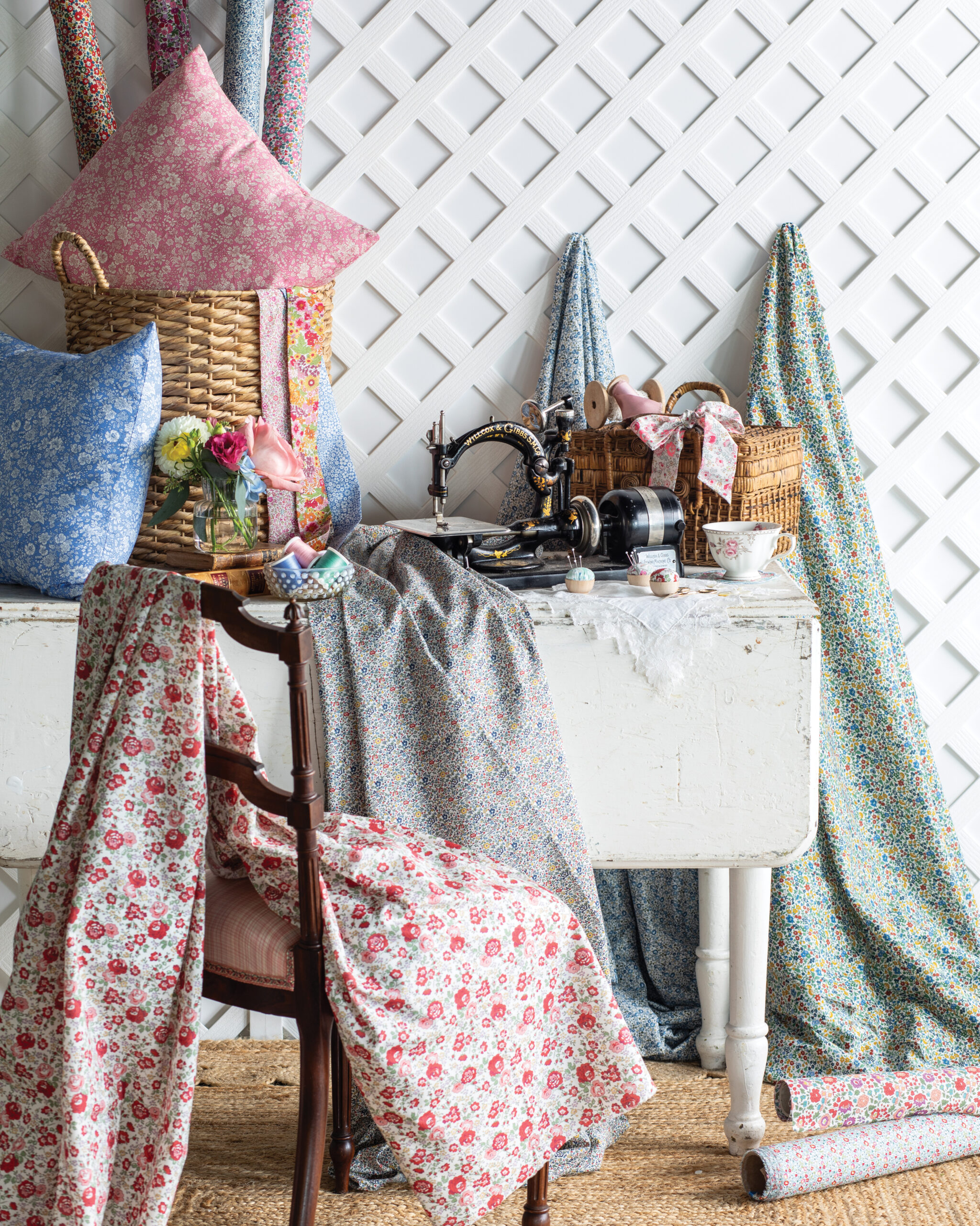 Sewing table and chair with floral fabrics laid out
