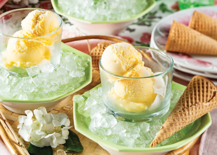 Mango sorbet in glasses next to ice cream cones