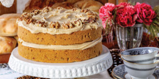 Coffee walnut cake on a white cake stand