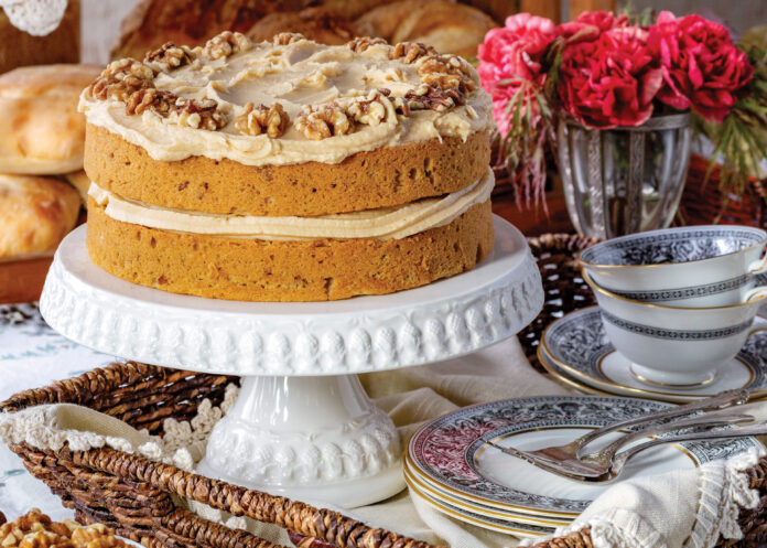 Coffee walnut cake on a white cake stand