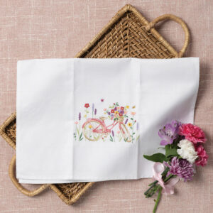 White hand towel with pink bicycle embroidery