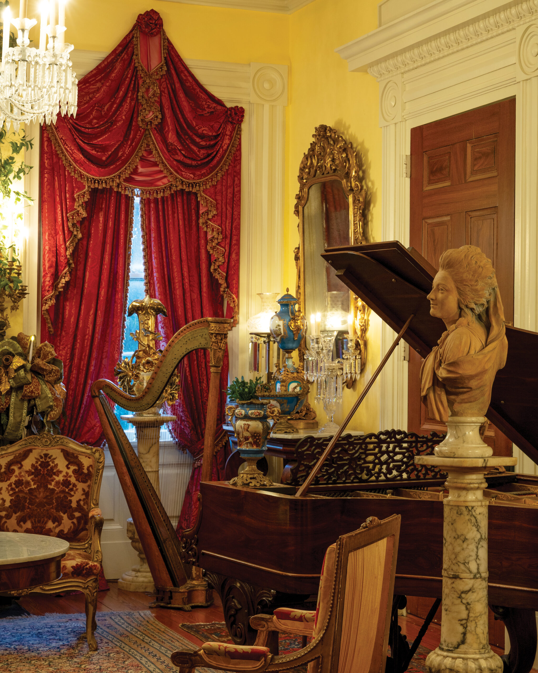 Piano, harp, and marble bust in ornate room