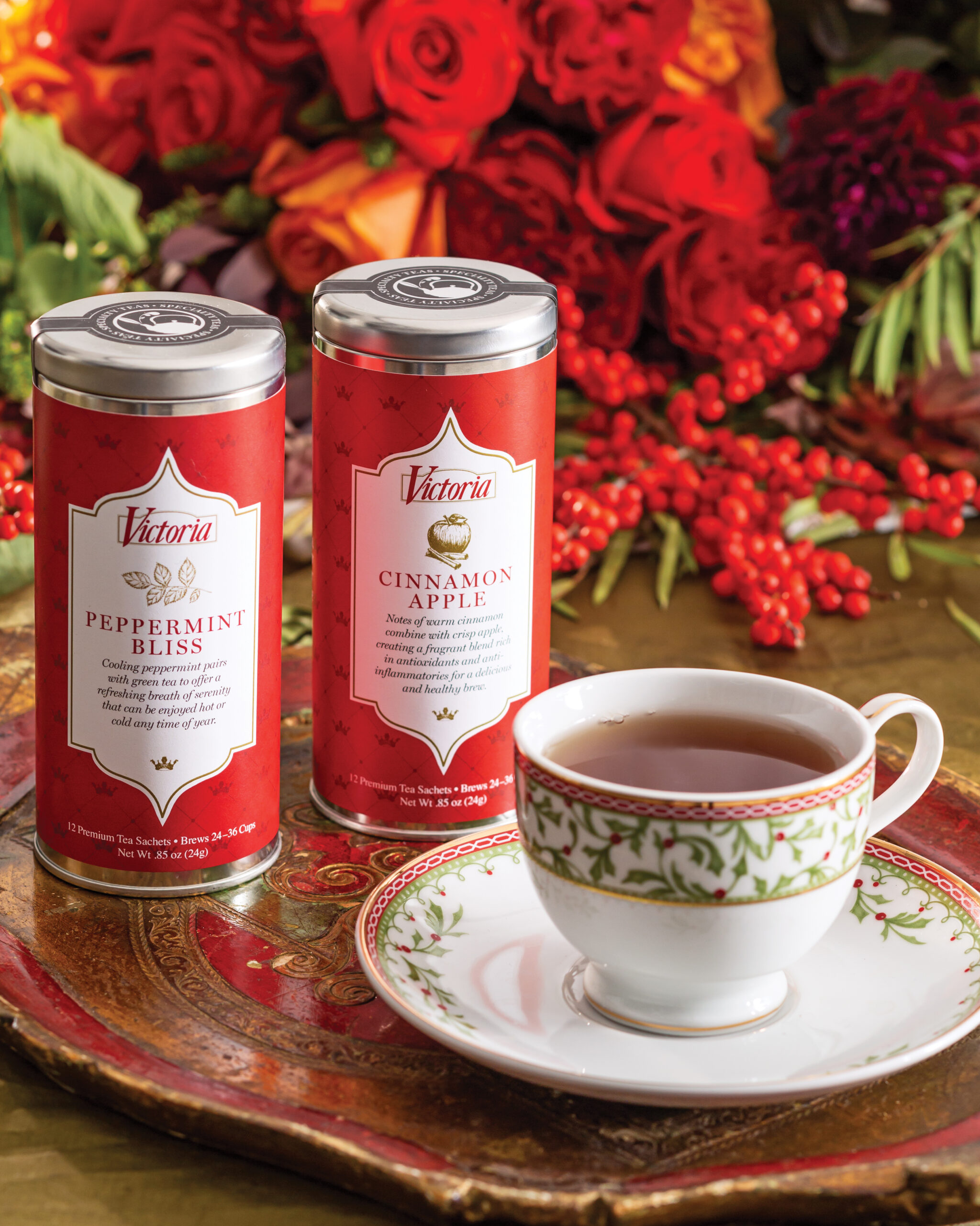 Holiday tea tins next to Christmas tea cup