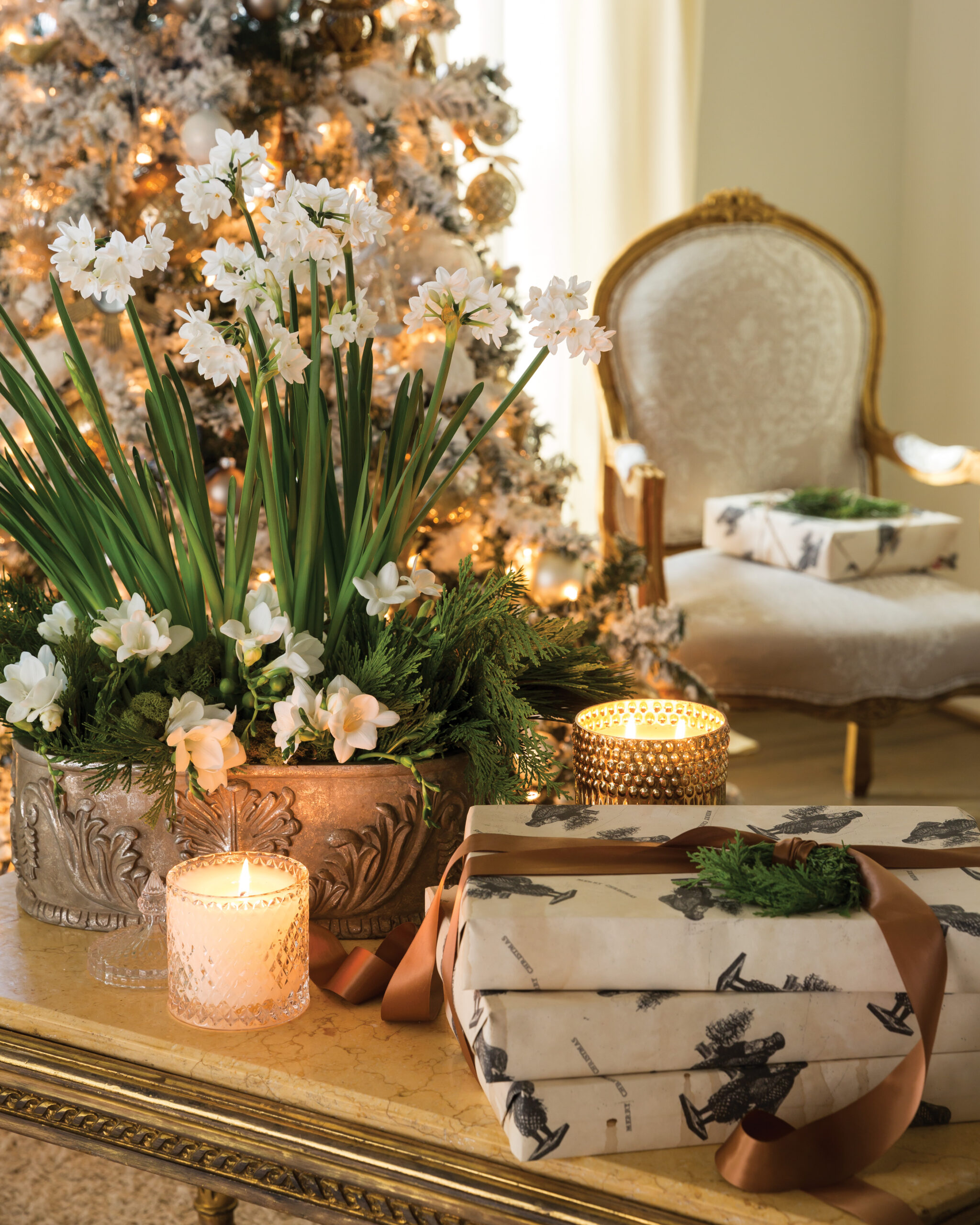 White flowers next to wrapped gifts and candles