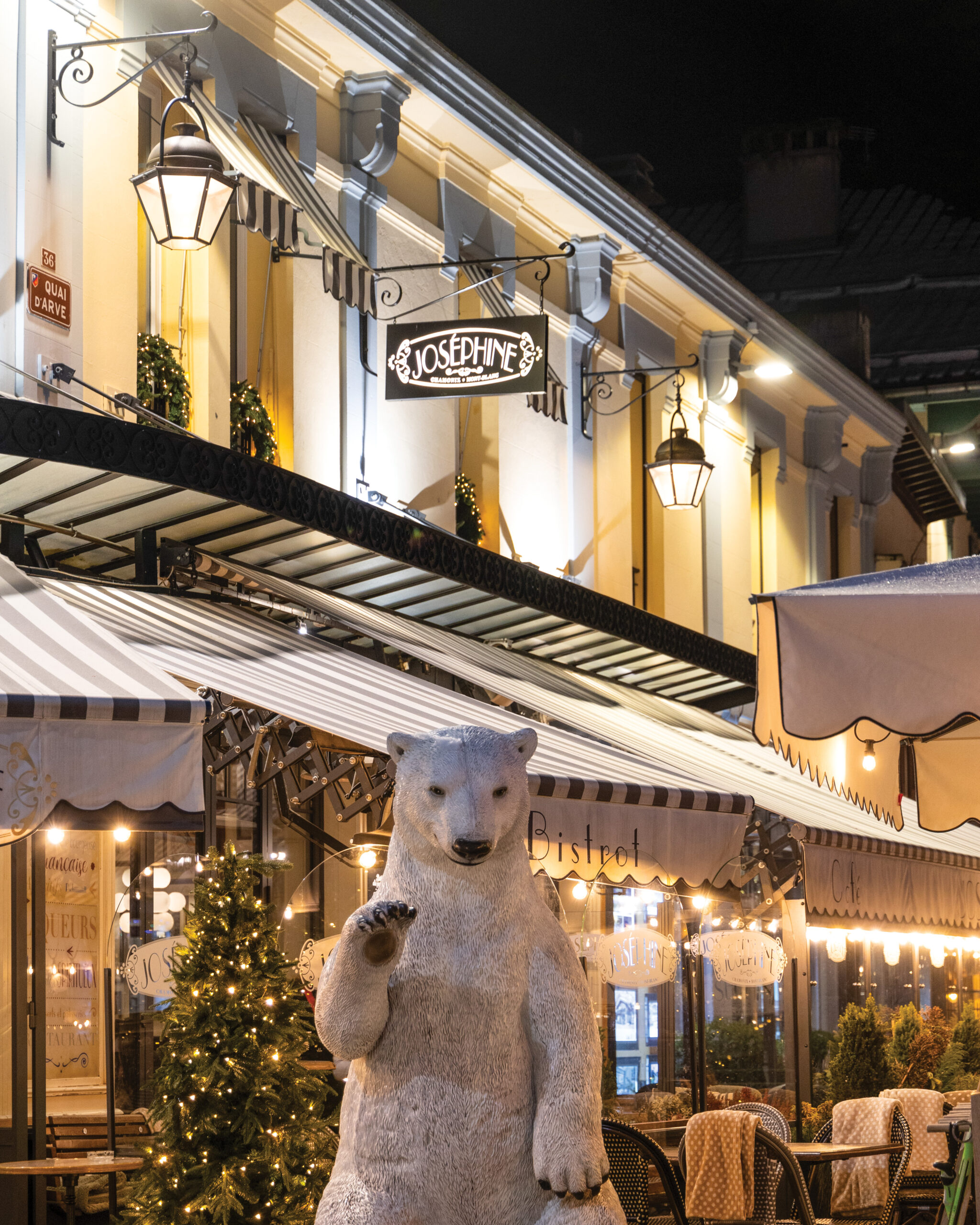 Town scene in Chamonix with polar bear statue outside of restaurants 