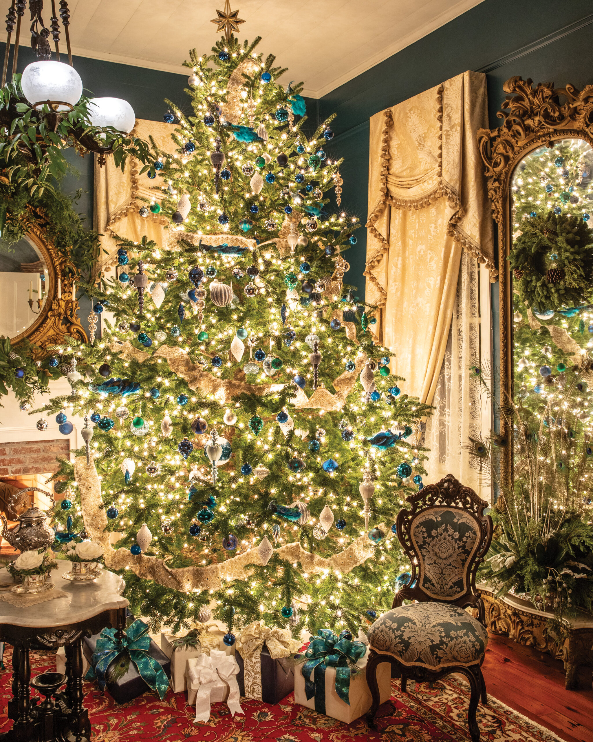 Blue-themed lit Christmas tree in sitting room