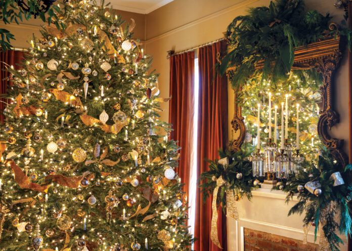 Christmas tree in living room next to fireplace