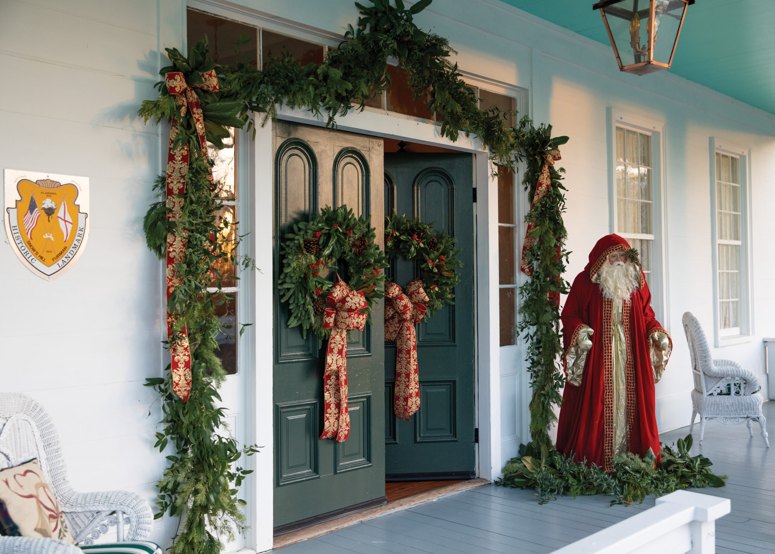 Front porch with wreaths and Santa figurine
