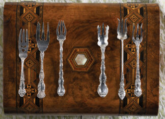 Silver collectibles on a wooden display case