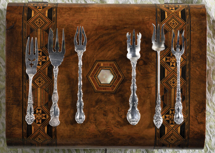 Silver collectibles on a wooden display case