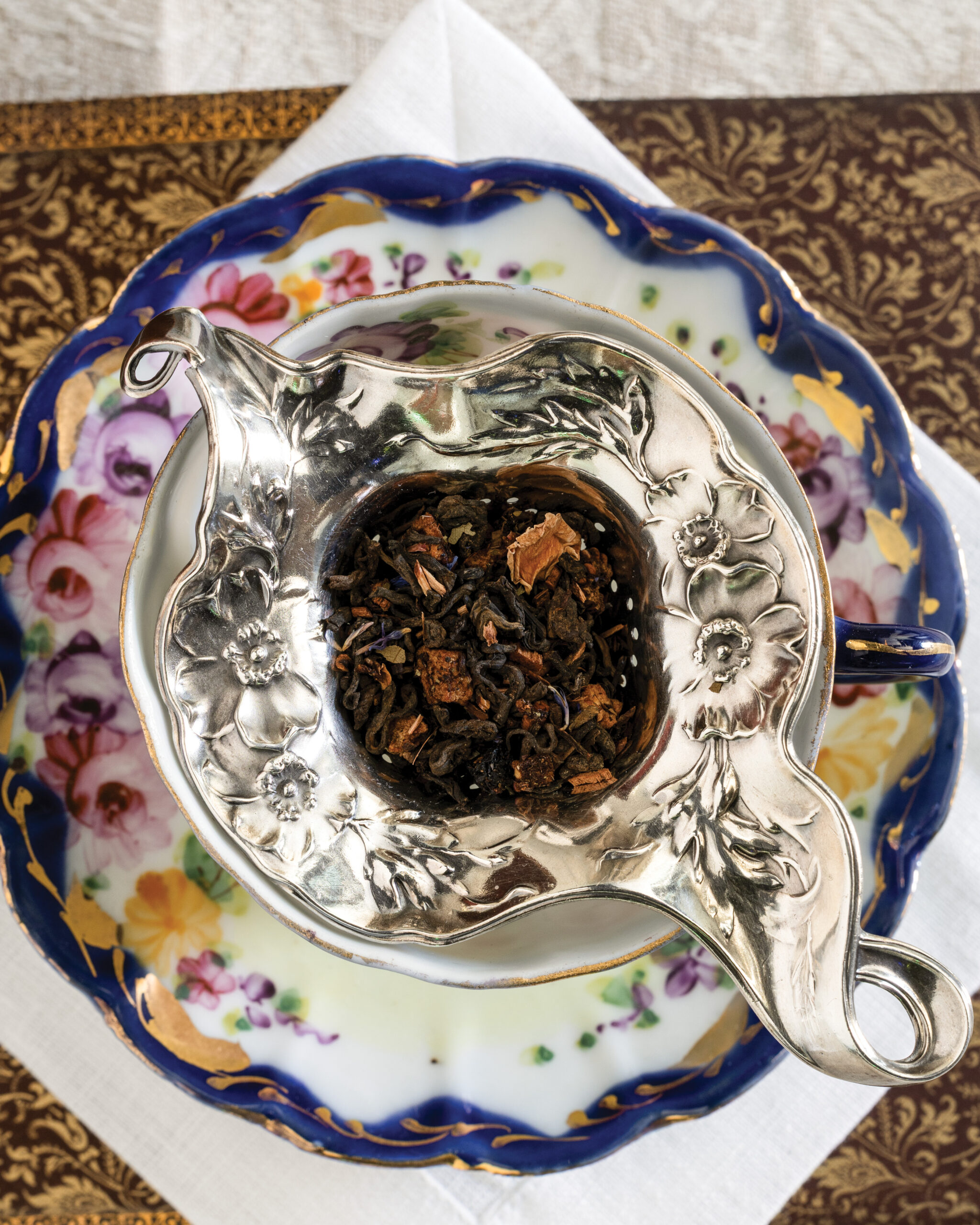 Silver tea strainer with loose leaf tea 