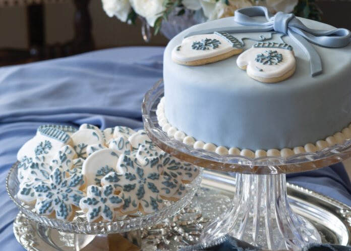 Blue wintry cake with white and blue snowflake cookies