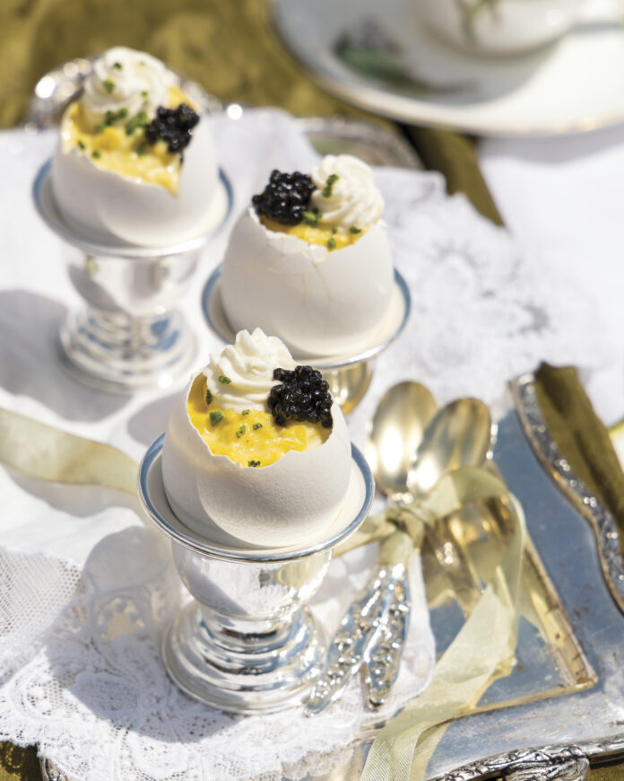 Caviar Eggs: carefully preserved eggshells filled with a silken egg custard, an airy crème frâiche mixture, the prized roe from various species of ancient sturgeon fish, and a sprinkle of chives.