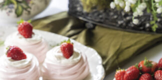 Blushing and dainty Mini Pavlovas hold lemon curd, whipped cream, and fresh berries.