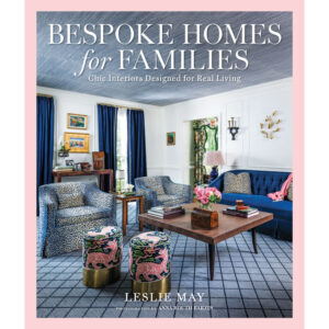 Book cover for Bespoke Homes for Families; a stylish living room with blue sofa and patterned chairs, author Leslie May.