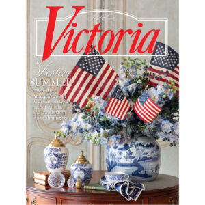 800x800VIC_CV1 - Victoria Victoria magazine cover featuring a festive summer bouquet with American flags, in a blue-and-white porcelain vase on a wooden table; prominent red 'Victoria' title and July/August text.