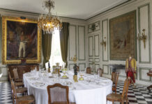 Gilded Refuge: Château de Valençay elegant dining with white tablecloth and chandelier