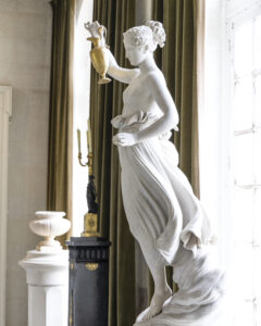 web - Victoria close up view of a statue of a woman holding a gold pot