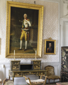 web_7 - Victoria elegant sitting room with a portrait of a man above a writing desk